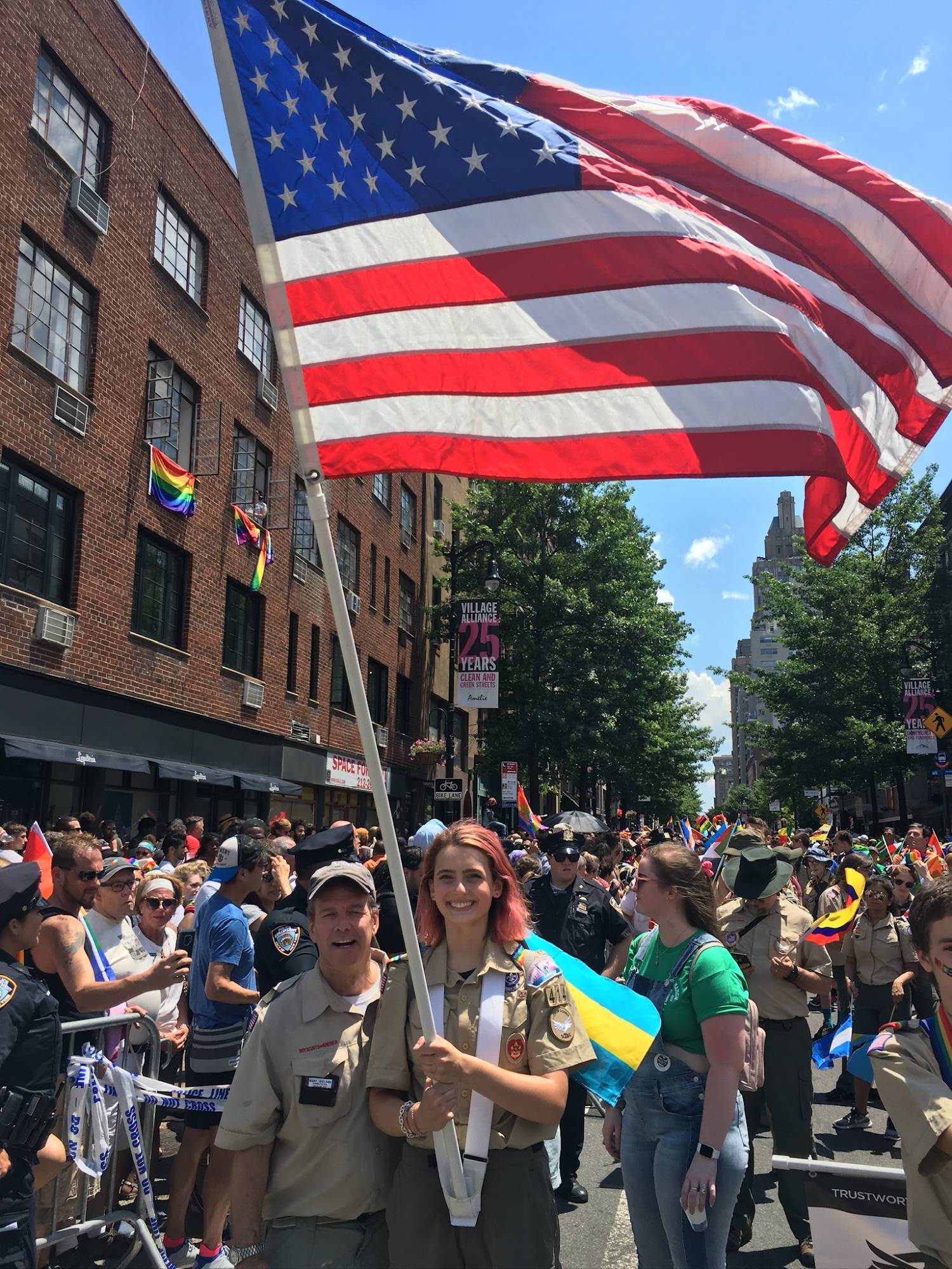 Sydney carrying a large American flag while marching in a parade